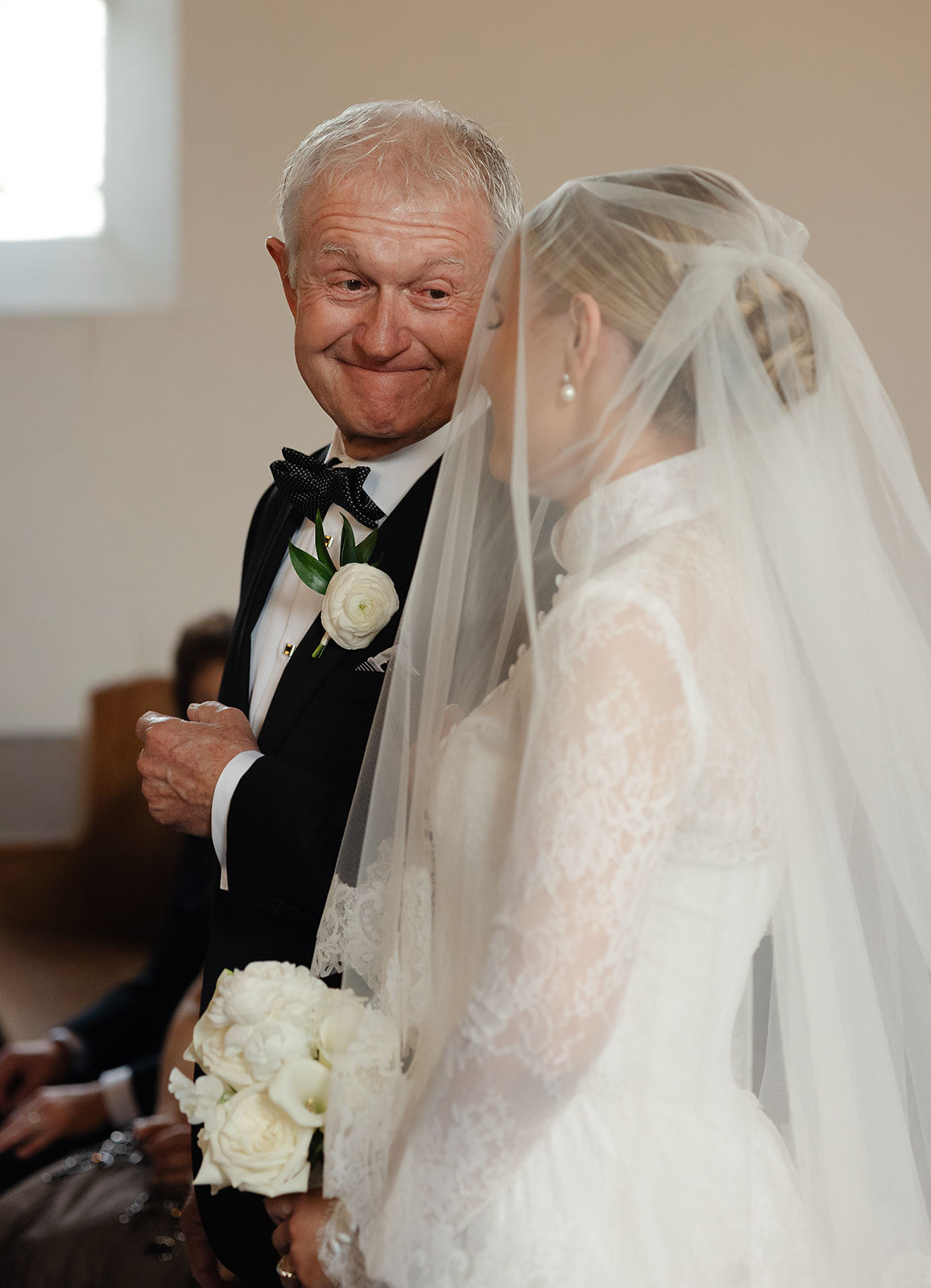 Candid photo of a special moment between bride and her dad while walking down the aisle. 