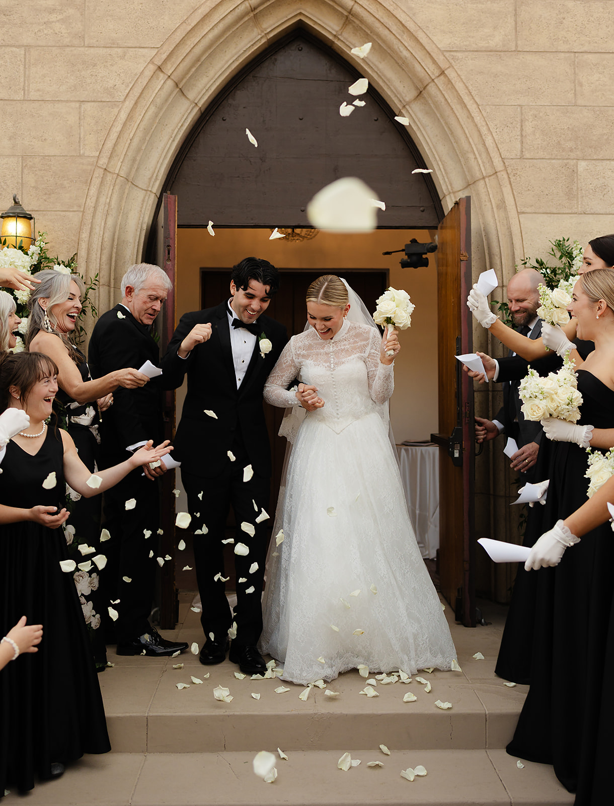 Newlyweds celebrating with a petal toss after their wedding ceremony in Phoenix at The Woodland.