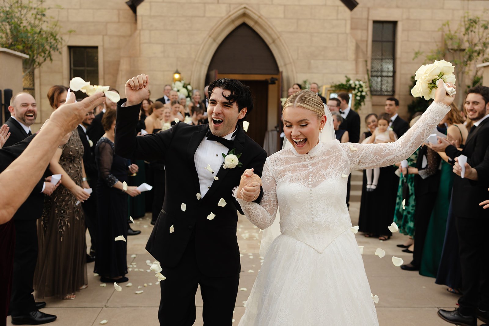 Petal toss celebration outside The Woodland Phoenix after wedding ceremony