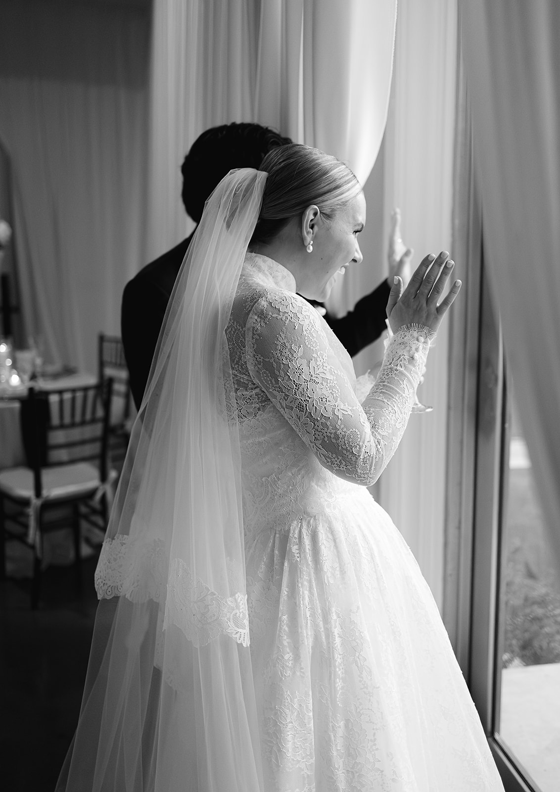 Candid moment of newlyweds waving at their guests during cocktail hour at The Woodland in Phoenix.
