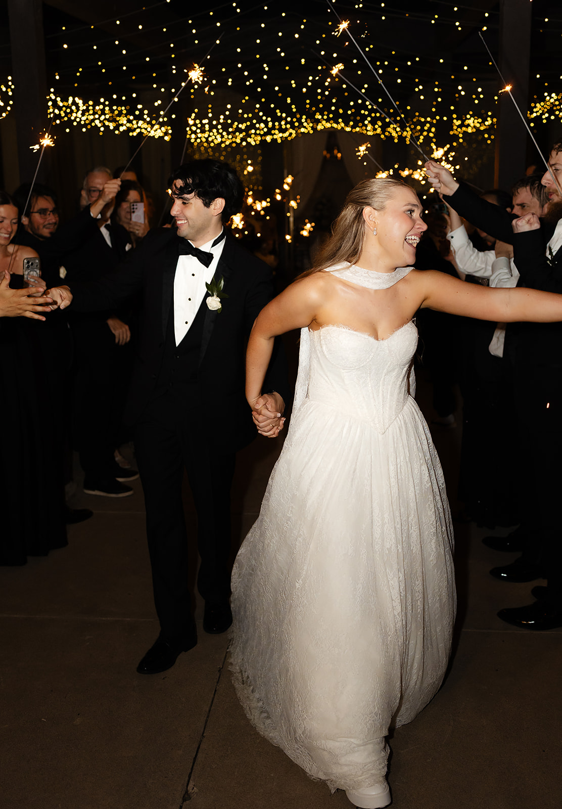 Newlyweds walking through sparkler exit at Phoenix destination wedding after all day coverage wedding photography