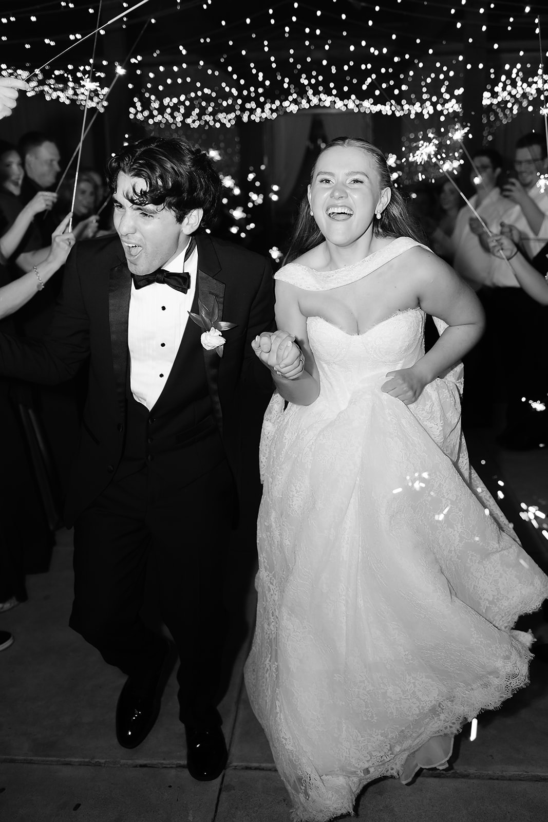 End of night sparkler exit for bride and groom leaving their wedding. 