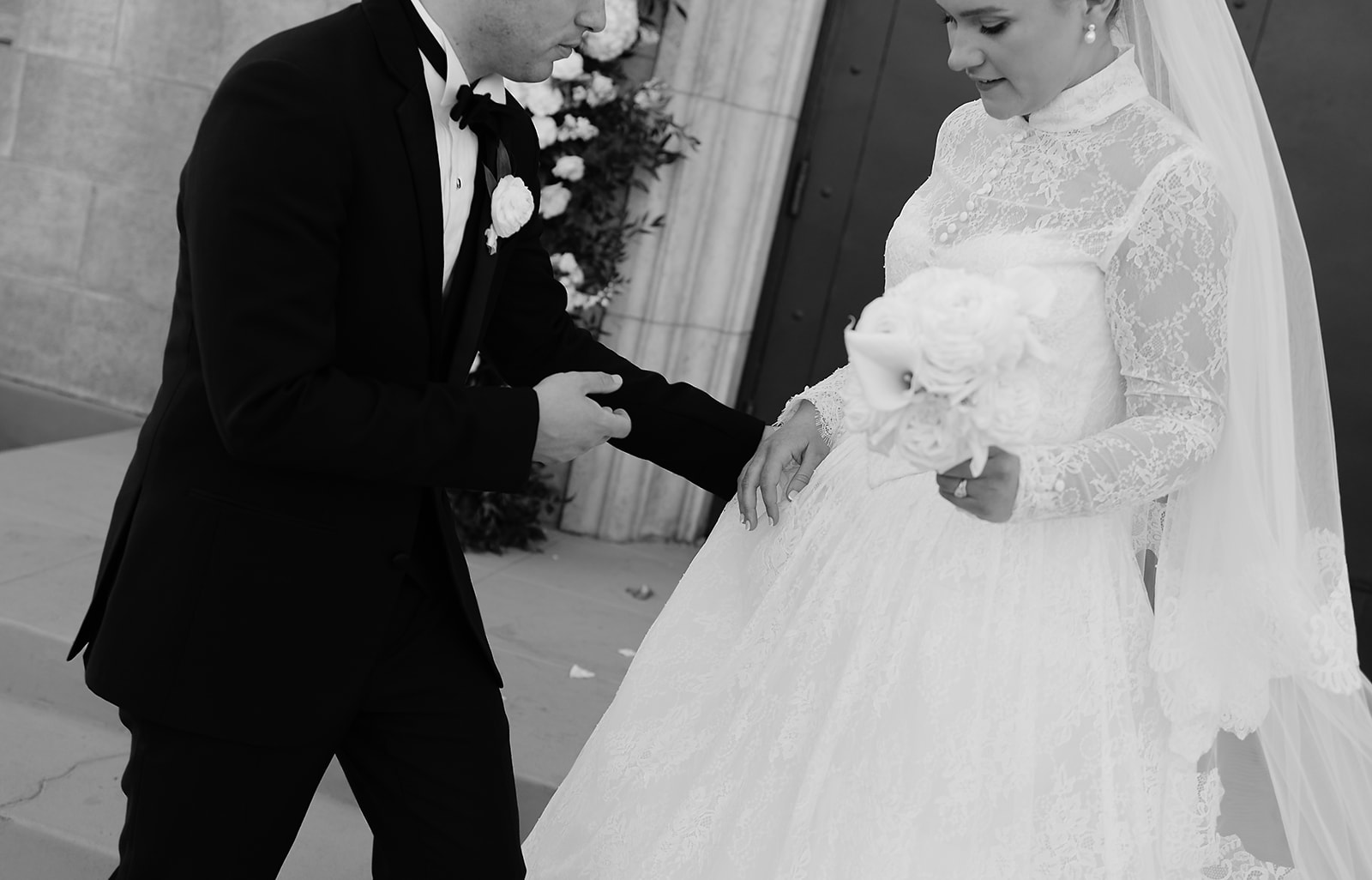 Loose editorial candid photo of bride and groom exiting wedding venue in Phoenix. 