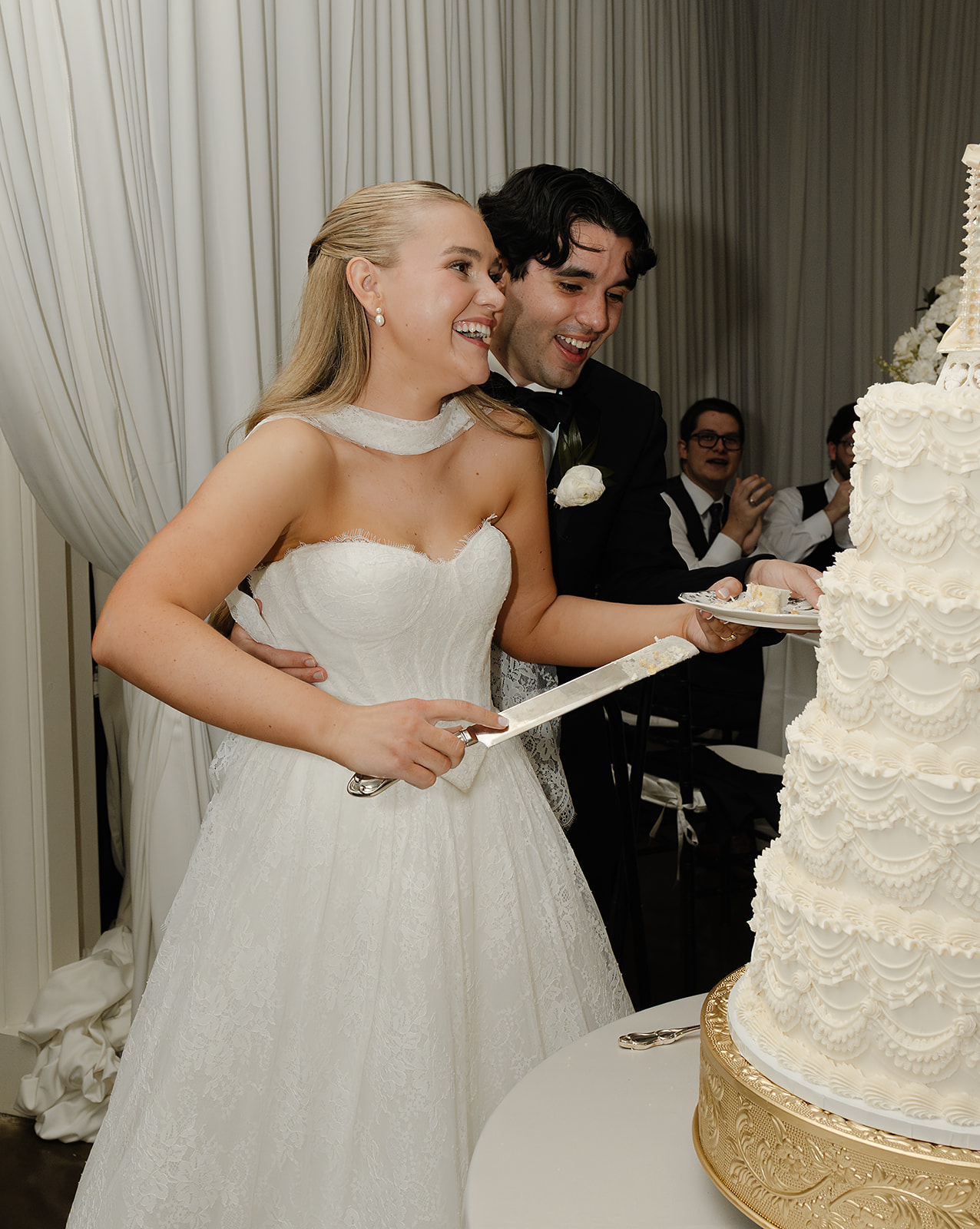 Bride and groom cutting cake during wedding reception at downtown Phoenix venue. 