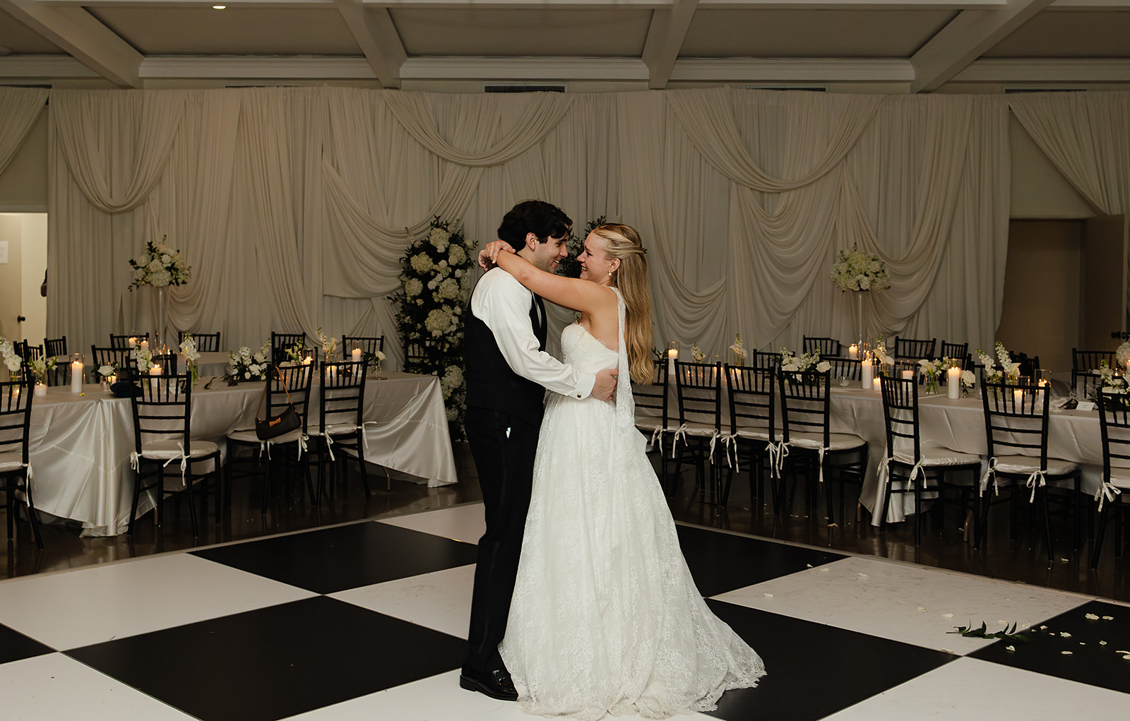 Couple sharing private last dance in candlelit reception space