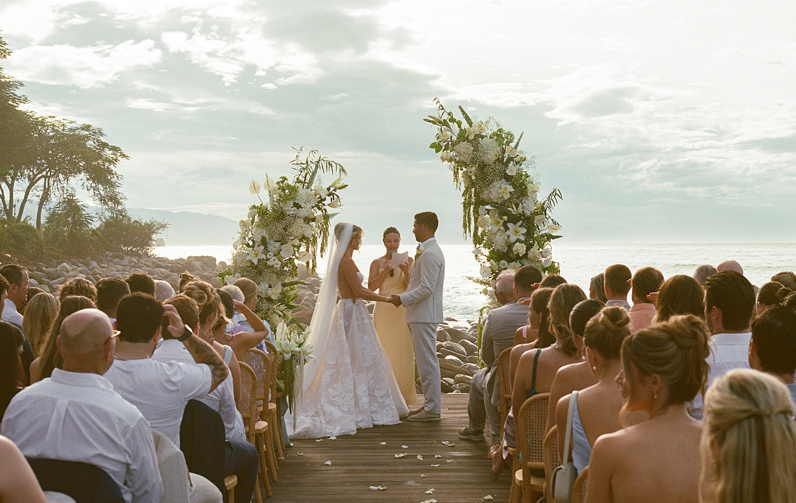 Wide view of oceanfront wedding ceremony in Mexico taken on 35mm film