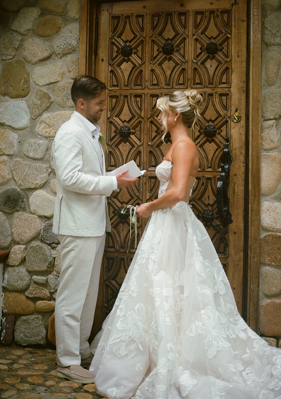 Film photo of bride and groom reading vows at private villa wedding