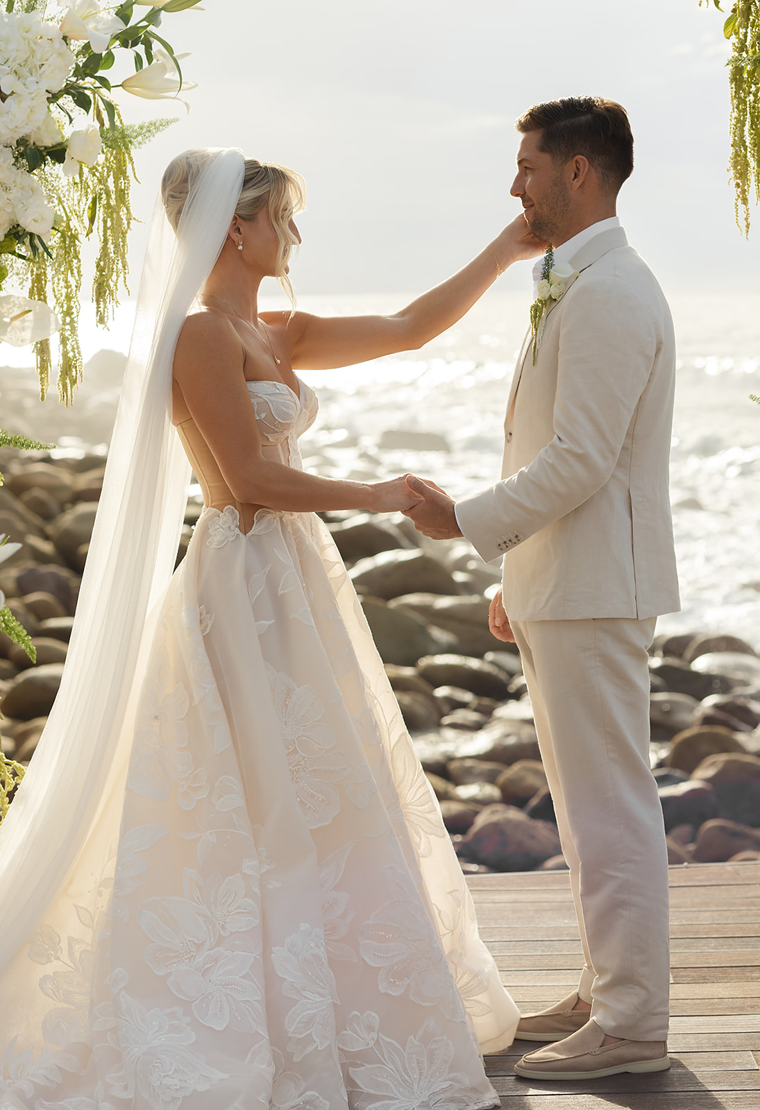 Couple exchanging vows above ocean at destination wedding in Mexico