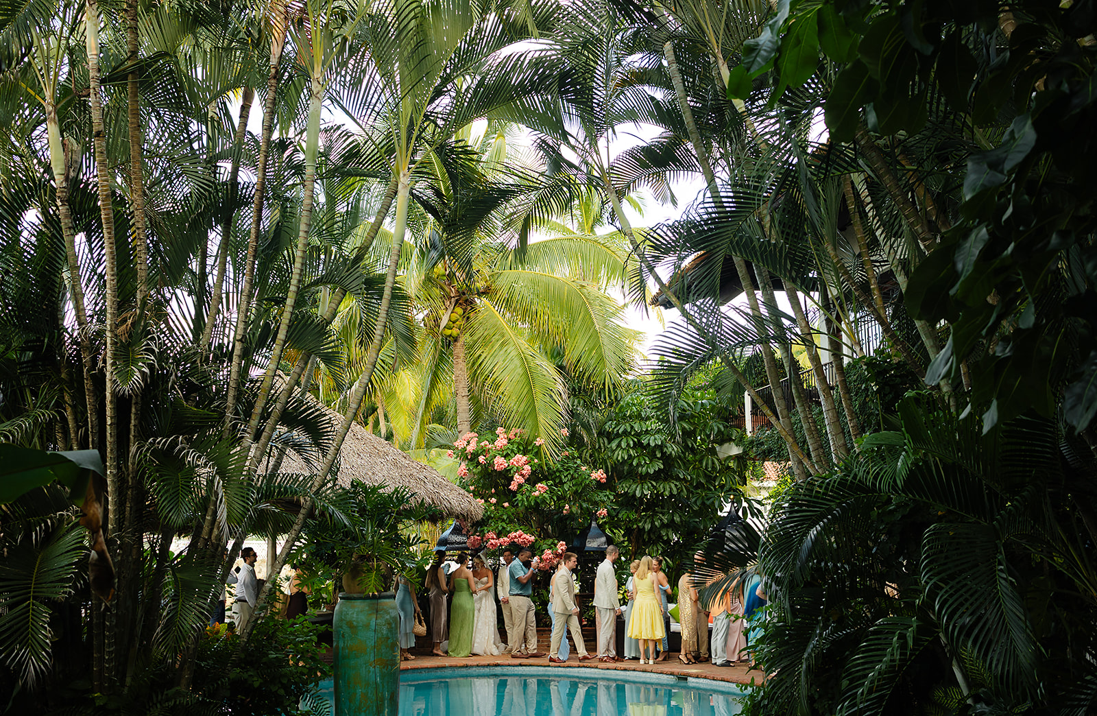 Guests mingling outdoors at coastal villa during cocktail hour