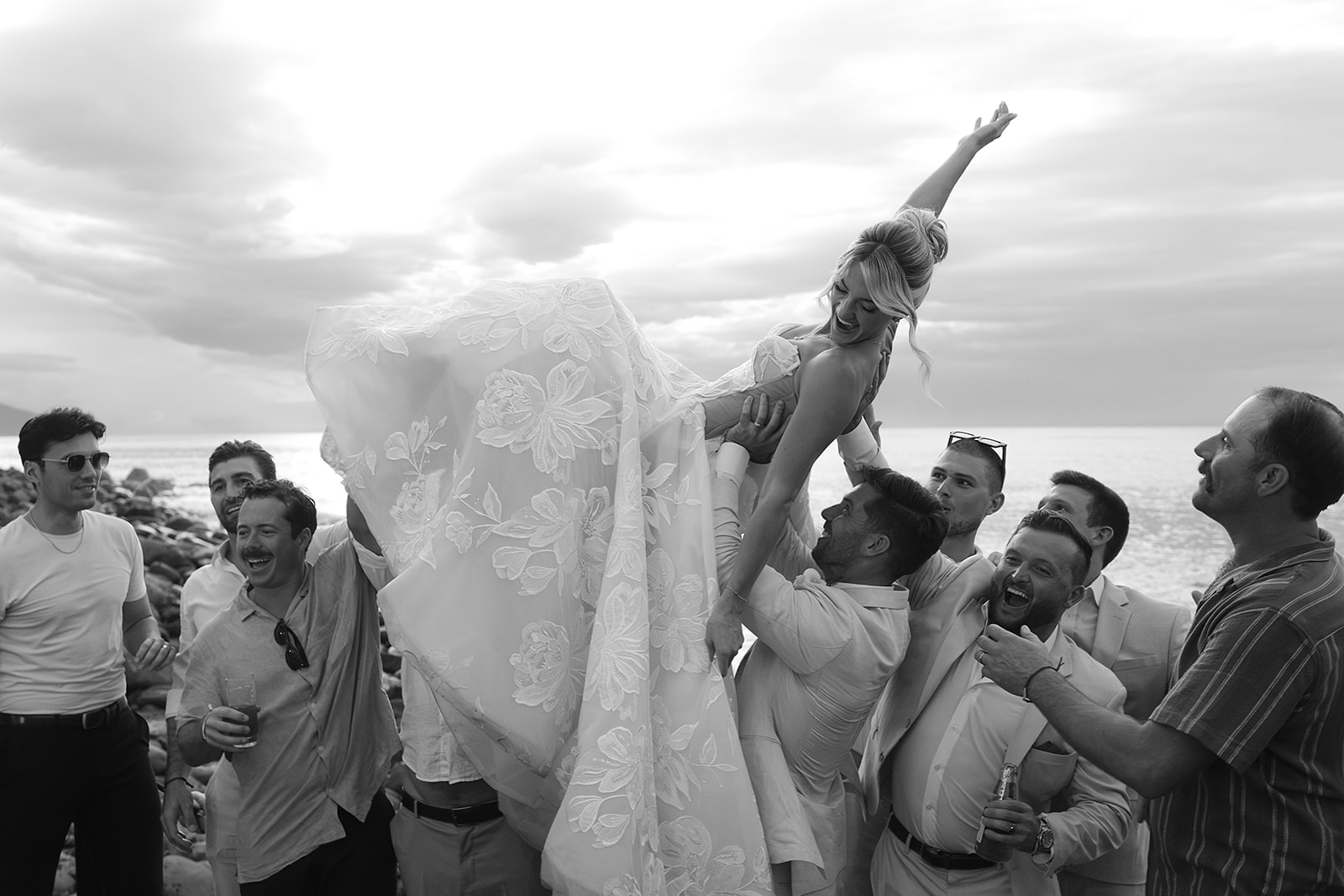 Guests lifting bride in celebration after ceremony at private villa wedding
