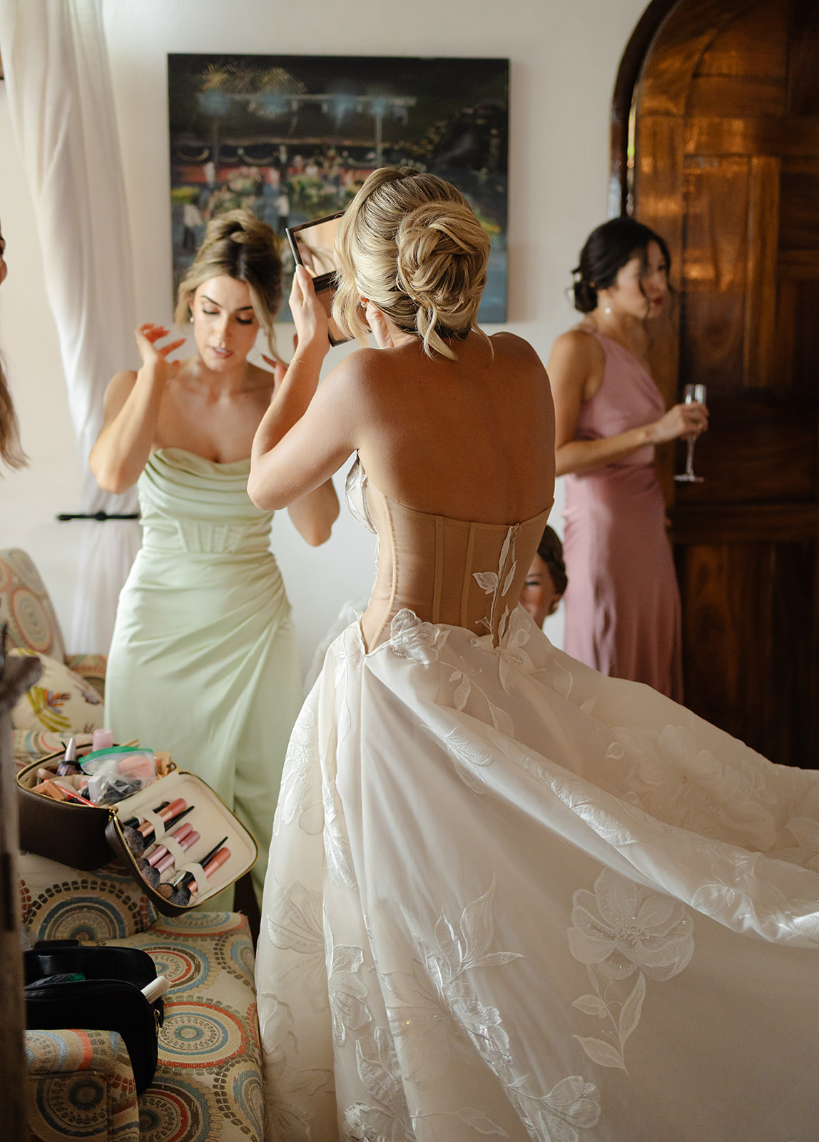 Documentary style photo of bride touching up makeup during wedding day in Mexico