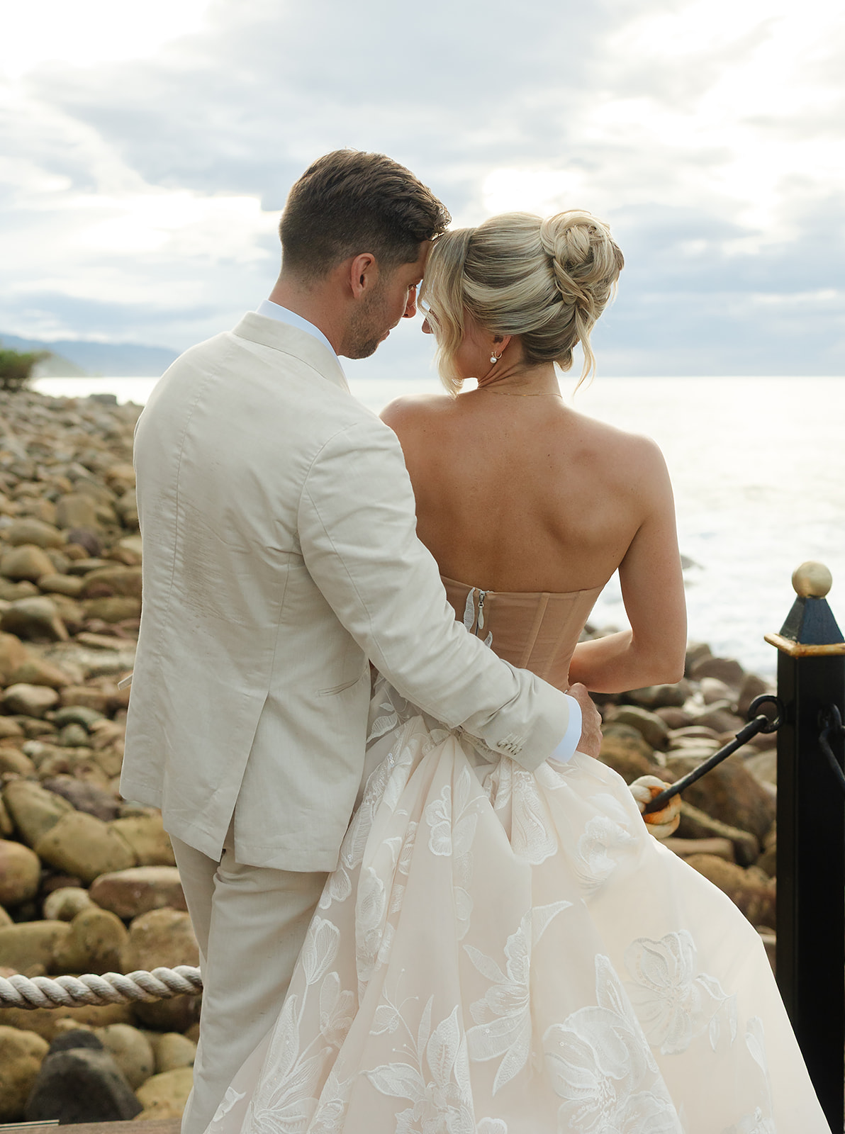 Film portrait of bride and groom overlooking ocean horizon in Puerto Vallarta