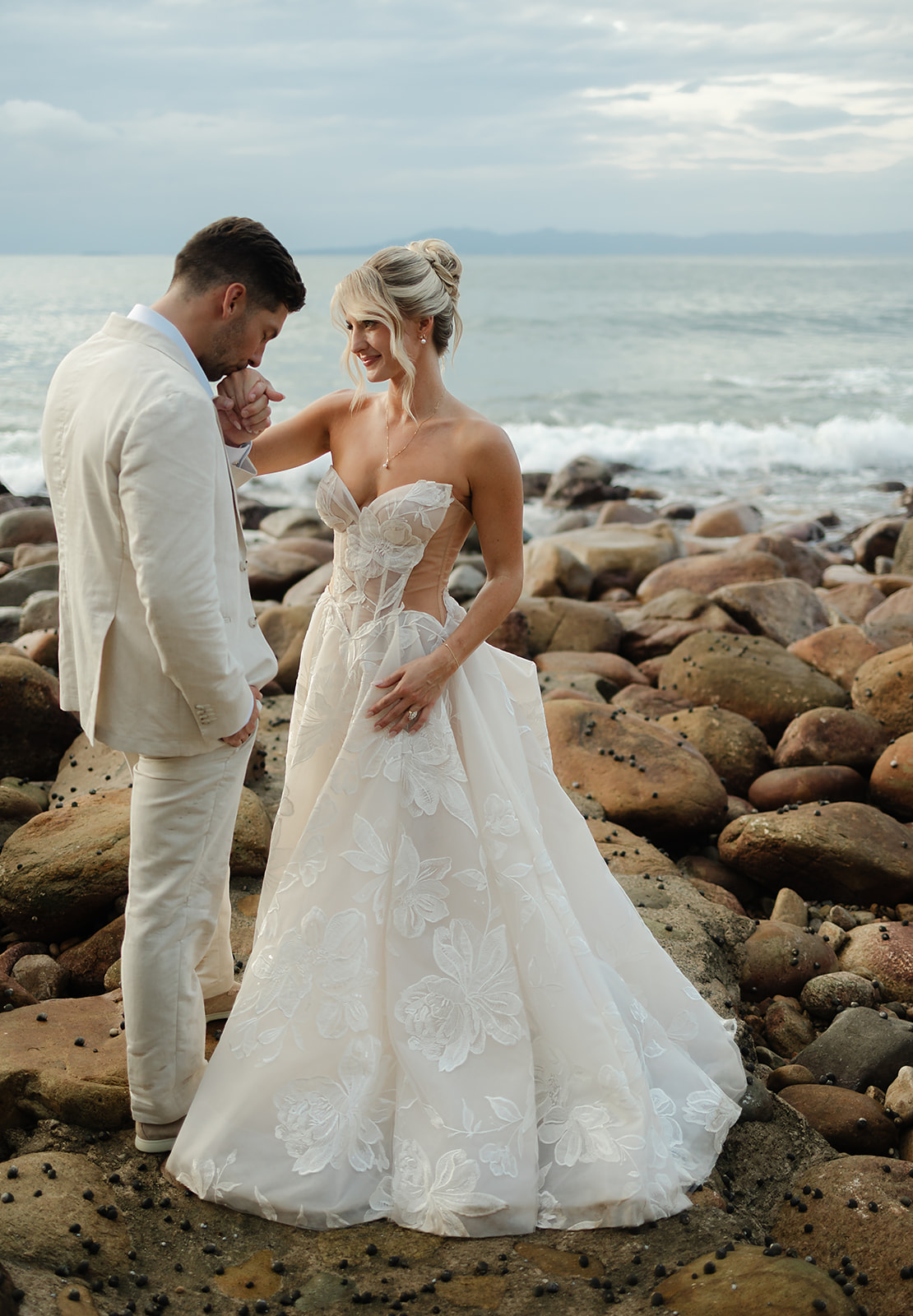 Intimate couple moment during sunset portraits on tropical coastline