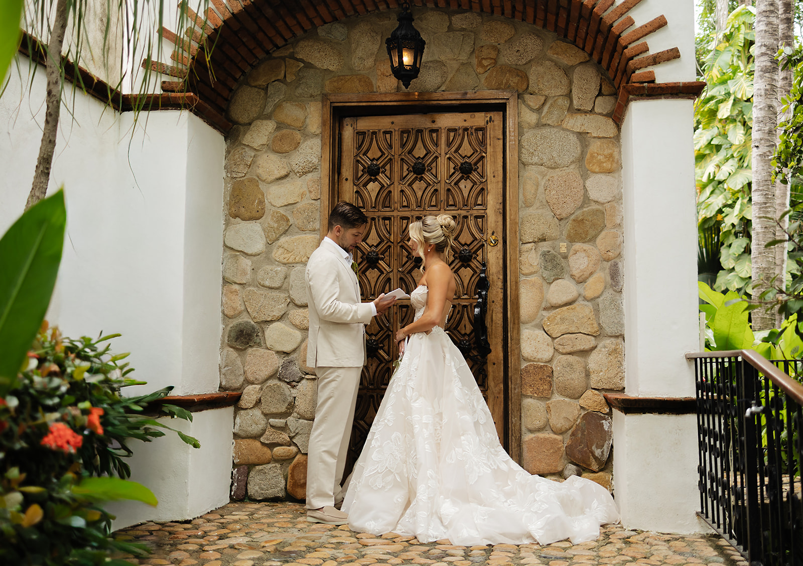 Bride and groom reading private vows to each other before wedding ceremony at private villa in Puerto Vallarta