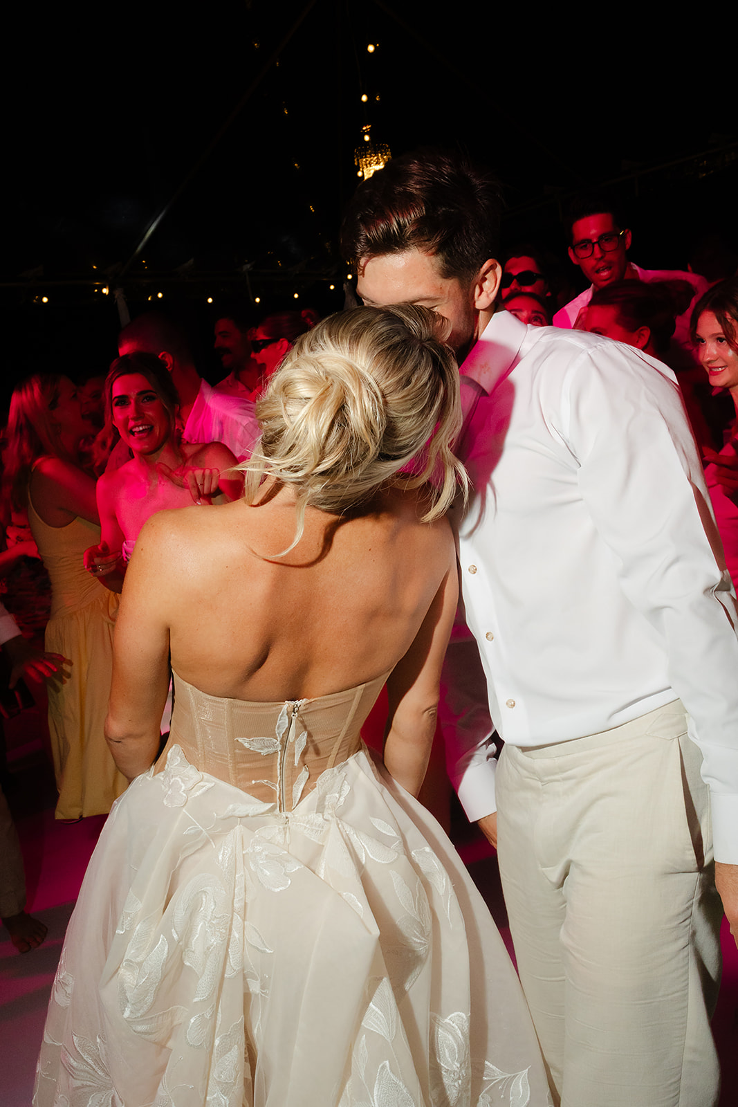 Colorful reception lighting creating vibrant party atmosphere at villa at Mexico wedding