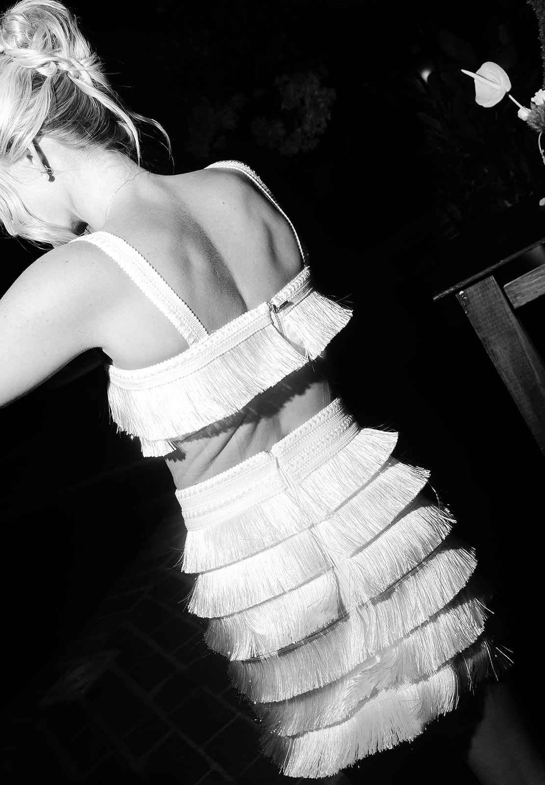 Bride changing into short two-piece reception outfit for dance floor, direct flash candid photo 