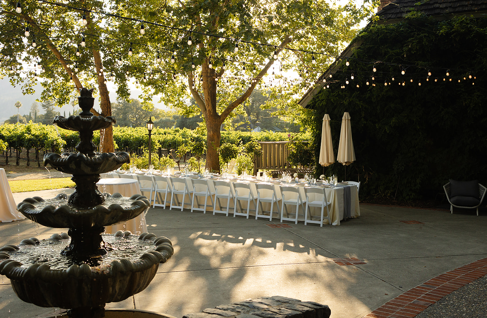 Dinner table and chairs set among greenery at Harvest Inn Napa Valley