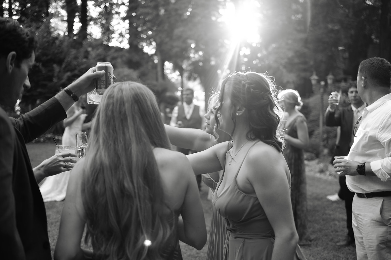 Candid moment between couple and guests during outdoor cocktail hour