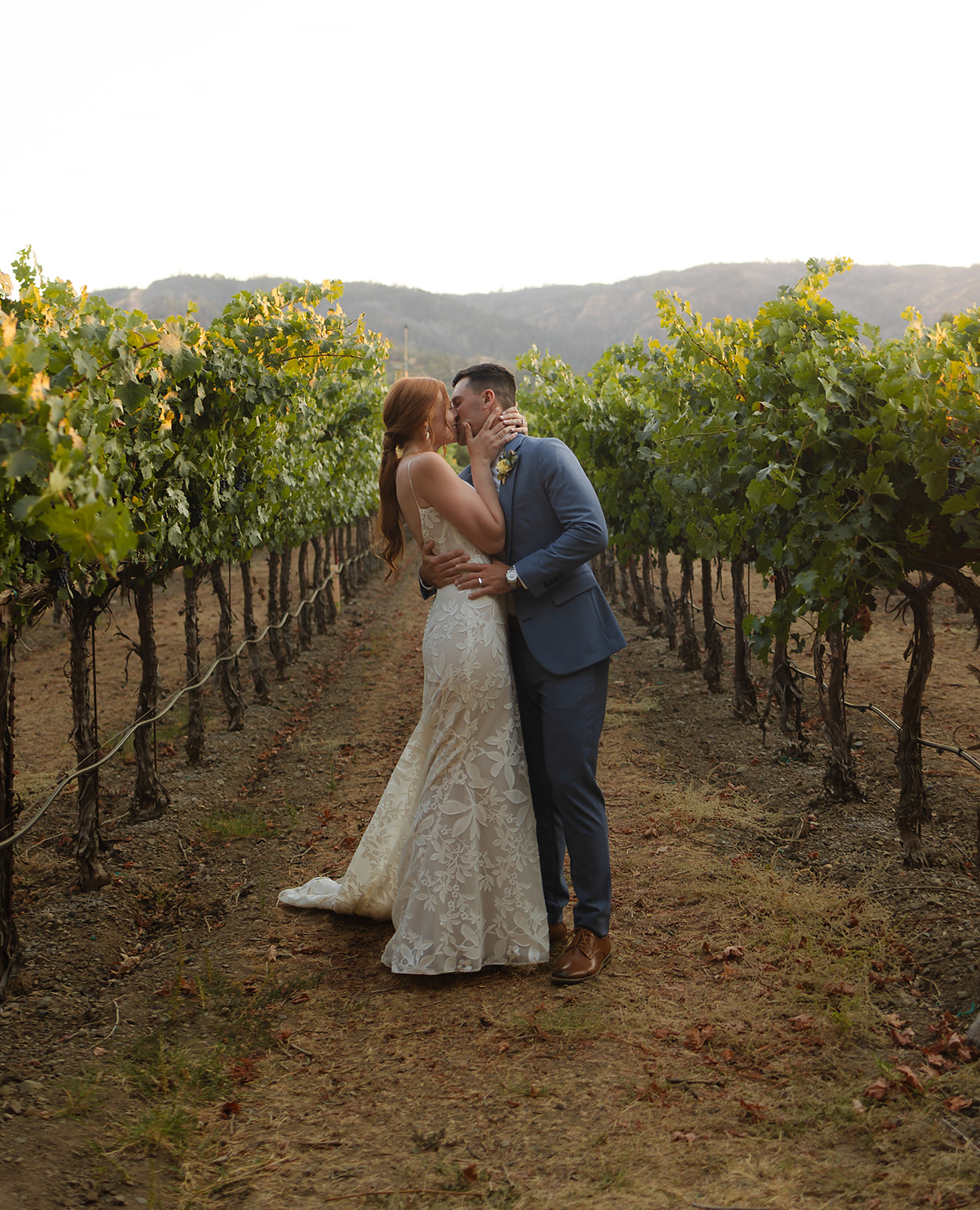 Bride and groom embracing during quiet moment after ceremony