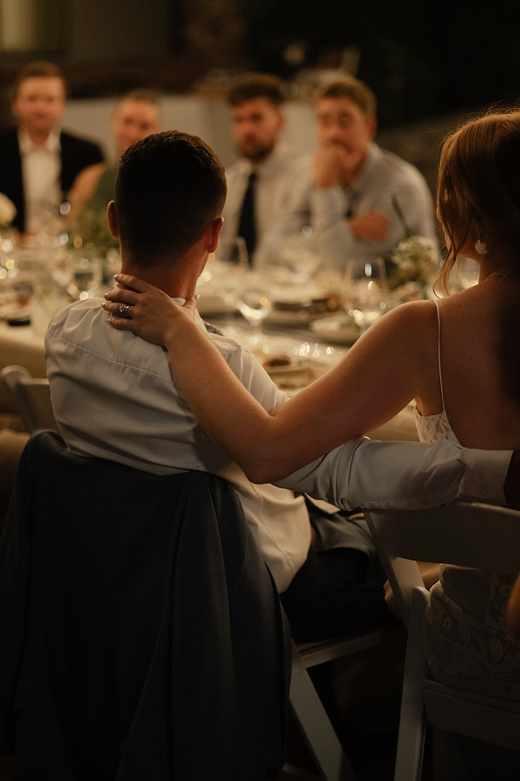 Sharing conversation during intimate wedding dinner outdoors